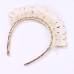 Detailed macro view of the anti-slip teeth and sparkling star tulle of the gold hairband