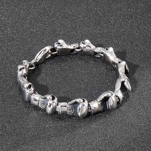 Detail of silver boxing glove charms on a heavy titanium steel hip-hop bracelet