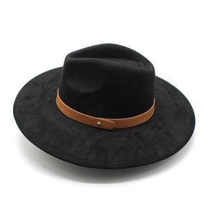 Detail of black fedora hat featuring a brown leather band and gold rivet accent