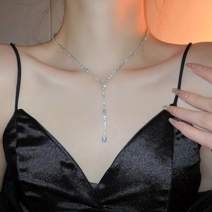 Detailed view of silver Y-shaped tassel necklace with sparkling teardrop rhinestones