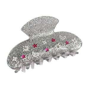 Silver glitter shark hair claw with pink and white rhinestone stars and moon decorations