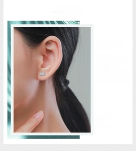Close-up of S925 silver stud earrings with three rectangular baguette zircons on model