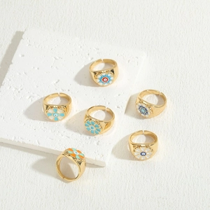 Set of six 14K gold plated evil eye rings with colorful enamel on stone texture