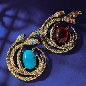 Retro snake brooch set in gold-tone metal with red and blue gemstone accents