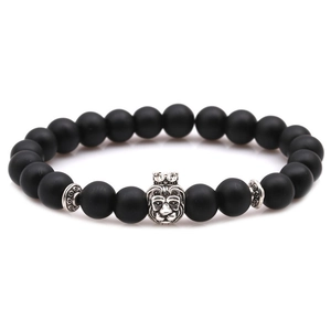 Matte black beaded bracelet for men featuring a detailed silver lion head crown charm