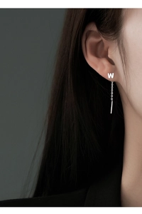 Macro view of S999 silver ear threader earring featuring a W-letter and long bar pendant
