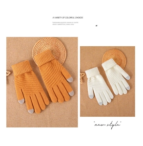 Detail of waffle-knit touchscreen gloves with warm ribbed cuffs in ginger and cream colors