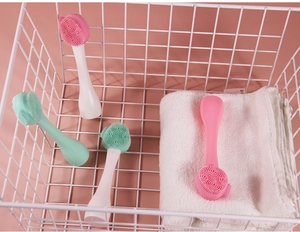 Silicone facial cleansing brushes with soft bristles in a basket for skincare use