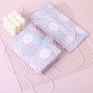 Pink and purple fish scale birthday gift box with light blue bow and pearl accents