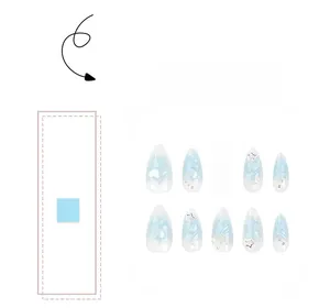 Detailed view of blue gradient almond press-on nails with 3D star heart and pearl charms
