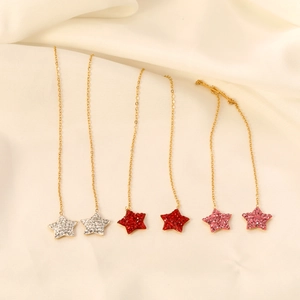 Gold long tassel chain earrings with star pendants in silver, red, and pink zircon