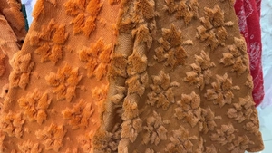 Close-up of heart-shaped leaf texture on plush orange and brown cushion covers