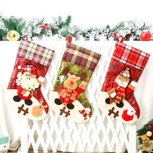 Close-up of three festive Christmas stockings with Santa, Reindeer and Snowman patterns