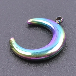 Macro shot of rainbow gradient moon-shaped pendant showing smooth polished metallic finish