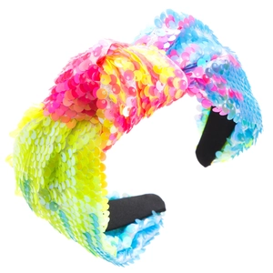 Close-up of vibrant multicolored sequins and knotted bow detail on a wide fashion headband