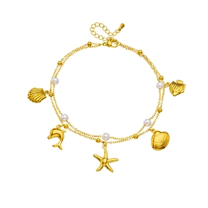 Layered gold stainless steel anklet with ocean shell and starfish charms on white background