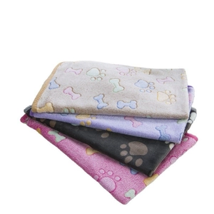 Stack of thick flannel pet blankets with paw and bone prints in grey, purple, pink and black