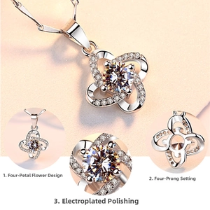 Close-up of four-prong setting on silver floral necklace with large round zircon stone