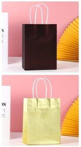 Detail of metallic gift bags with woven handles in bronze and gold finishes