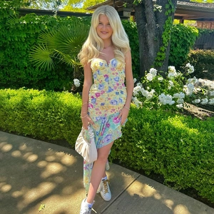 Detailed view of floral print pattern and ruched bodice on a slim fit fishtail dress
