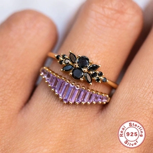 Elegant 925 sterling silver stacked ring set with black and purple gemstones on hand