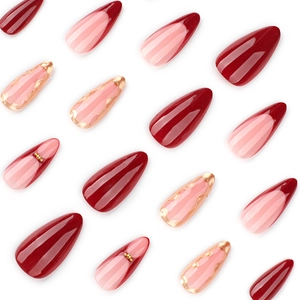 French red almond press-on nails with wine red tips and gold wave accents on white background