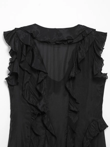 Detail of black sleeveless V-neck dress with layered ruffles and soft chiffon texture