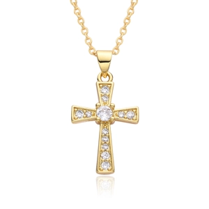 Macro shot of gold cross necklace pendant with micro-inlaid stones and elegant reflection