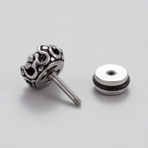 Detail view of silver stainless steel stud earring with embossed pattern and screw back