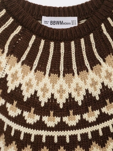 Detailed view of Fair Isle geometric knit pattern and brand label on a brown sweater