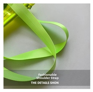 Detail of neon green nylon webbing strap and yellow transparent PVC beach bag texture