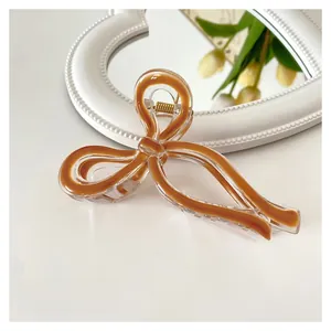 Detail view of 11cm jelly bow hair claw clip with clear amber resin finish and sleek design
