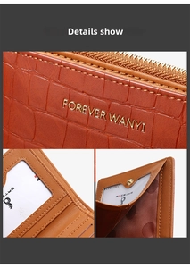 Detail view of brown crocodile texture wallet with metal zipper and clear card slots