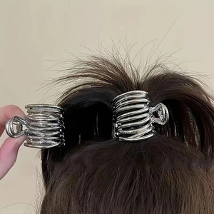 Close-up of small silver alloy hair claw clips securing a high ponytail for women