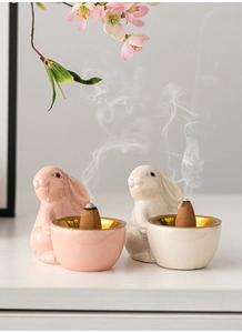 Ceramic bunny incense burners with gold trim, featuring pink and beige cute rabbit designs