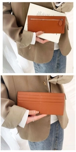 Detail view of brown lychee grain leather wallet with multiple card slots and silver zipper