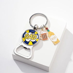 Detailed close-up of a metal bottle opener keychain with DAD and BEER cartoon charms