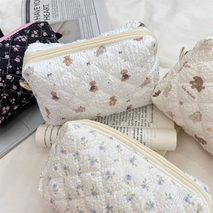 Detailed macro view of quilted pouches featuring cute bear and floral print patterns
