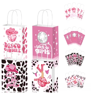 Detailed close-up of Disco Cowgirl gift bags featuring pink disco balls and cow patterns