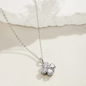 Close-up of S925 sterling silver clover necklace featuring heart-shaped zircon stones