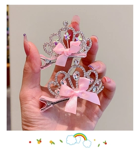 Detail of silver crown hair clips with rhinestones and pink satin bows for girls