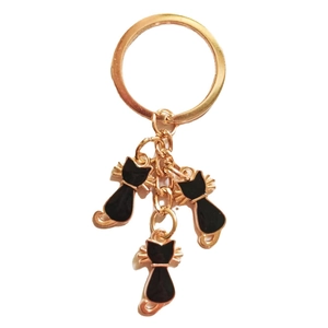 Fashion rose gold keychain with three black enamel cat pendants on a clean white background