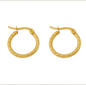 Detail of gold-plated twisted rope earrings with a polished finish and secure snap closure