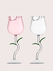 Detail of rose flower wine glasses with pink and clear bowls and green leaf stems