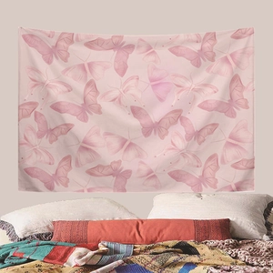 Detail showing pink butterfly tapestry hanging over a bed in a cozy bedroom setting