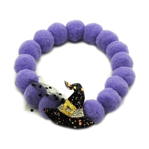 Detail of Halloween pet collar with purple pom-poms and a sequined black wizard hat