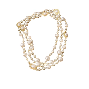 Elegant multi-layer pearl necklace with golden oval accents on a clean white background