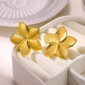 Vintage gold floral titanium steel stud earrings with textured petals in a white box