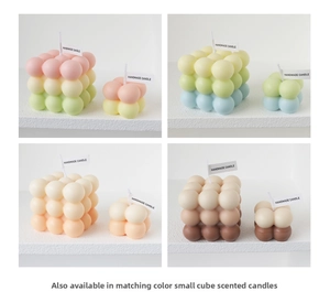 Close-up of handmade bubble cube scented candles in gradient macaron colors and two sizes
