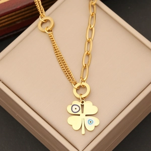 Detail of gold clover necklace featuring blue evil eye patterns and unique asymmetric chain